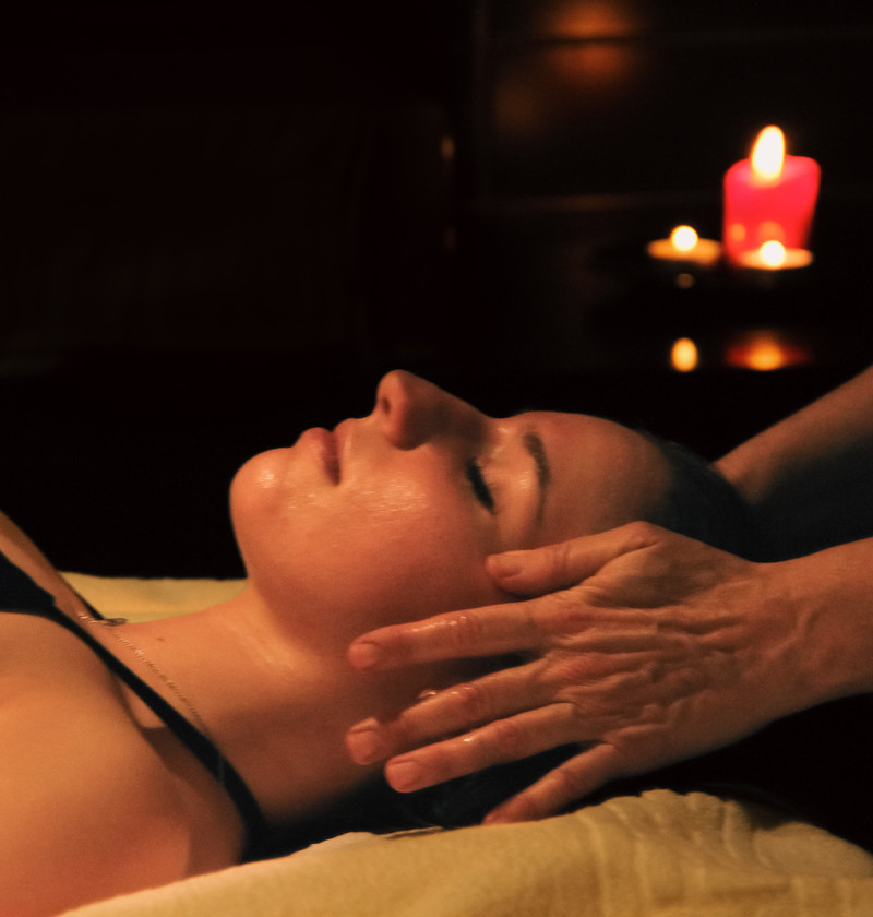 Relaxing massage in a candle-lit setting.